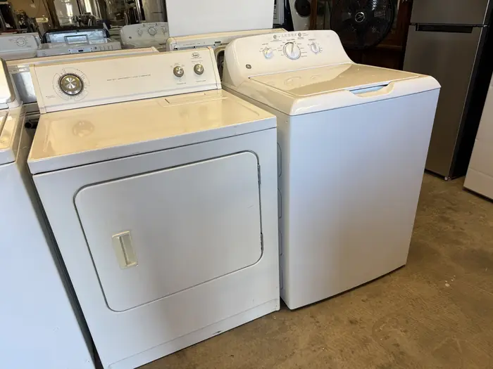 A white dryer and top-load washer side by side