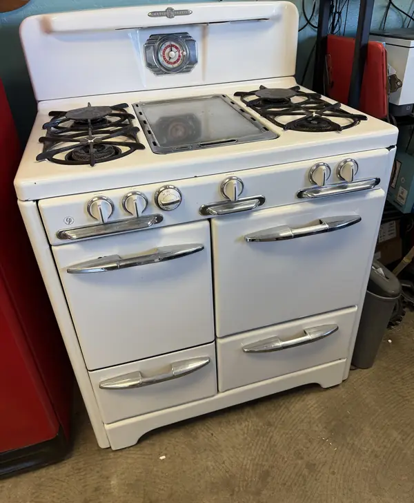 A classic white O'Keefe and Merritt gas range with chrome handles